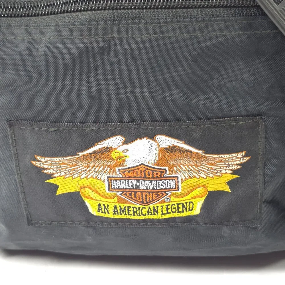 VINTAGE HARLEY DAVIDSON AN AMERICAN LEGEND BLACK DUFFLE BAG WITH SHOULDER STRAP.
